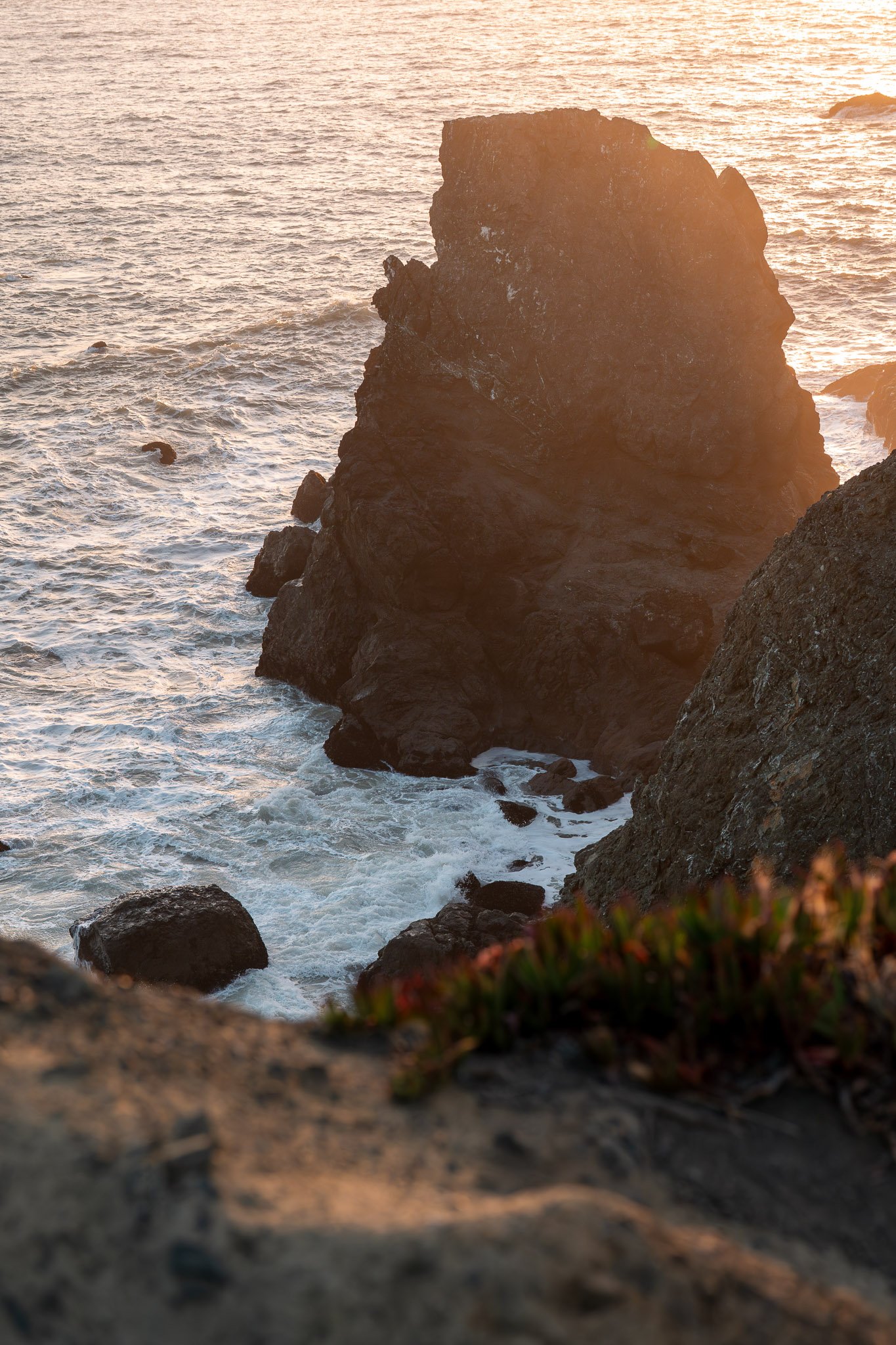 Majestic cliffs bathed in warm golden light during a vibrant sunset over the ocean