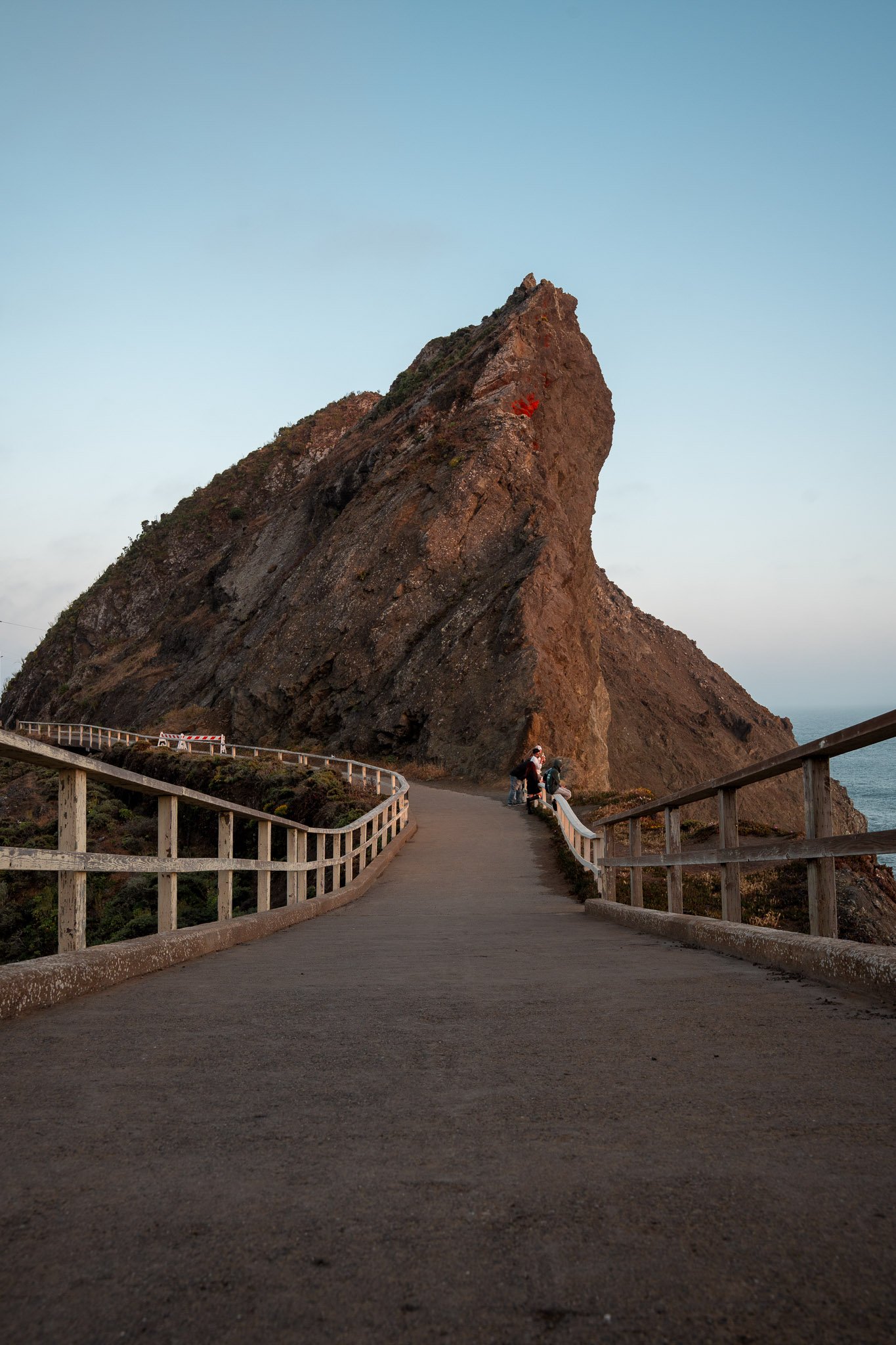 Point Bonita Lighthouse at dusk with soft fading light over the Pacific Ocean and rugged Marin coastline