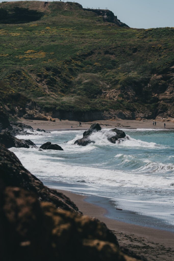 Waves Crash on the Beach Waves crashing over the rocks onto the beach